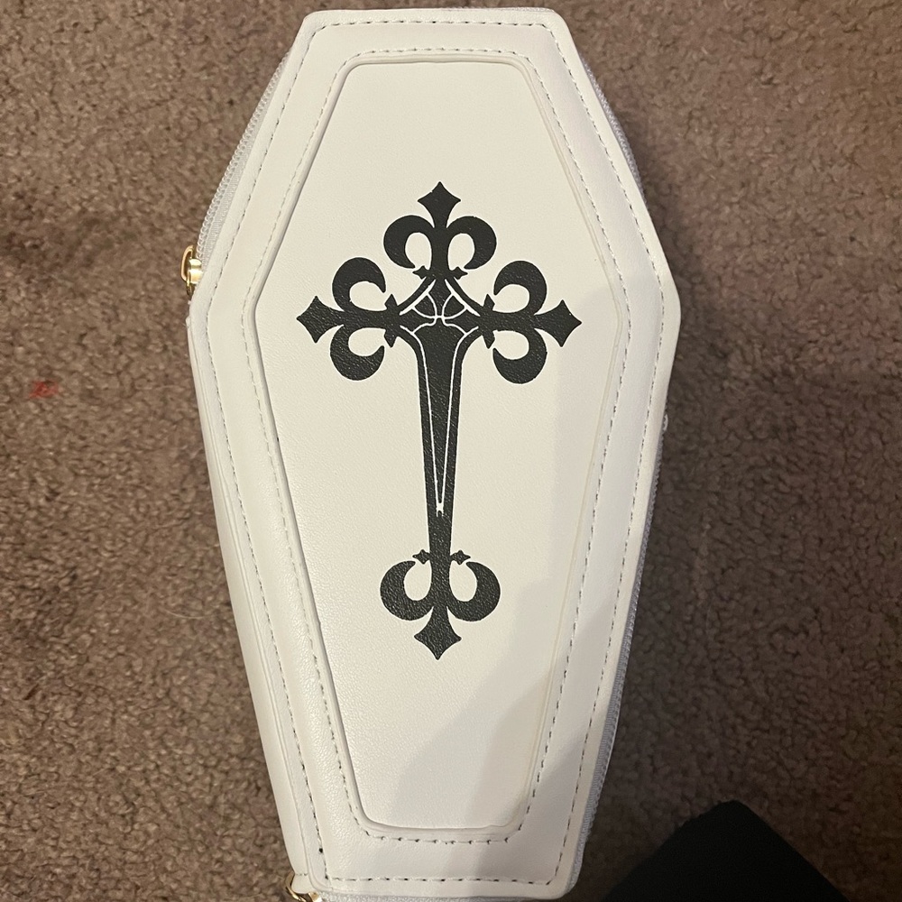 Tombstone shaped crossbody bag.